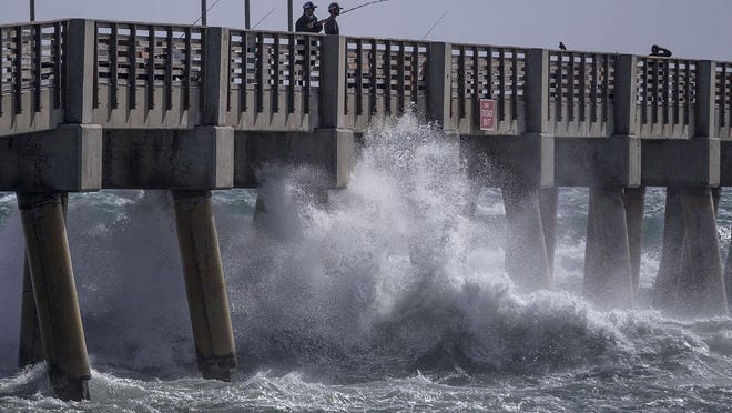 The wind pushes the waves against the Lake Worth Beach pier on March 28, 2019, in Lake Worth Beach. The city announced Tuesday that the pier is temporarily closed due to harsh weather conditions expected this week.
