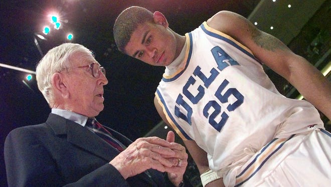 Former UCLA coach John R. Wooden talks with UCLA guard Earl Watson following UCLA's victory over Oklahoma State at the John R. Wooden Classic at Arrowhead Pond in Anaheim, Calif., Saturday, Dec. 5, 1998. UCLA beat Oklahoma State 69-66.