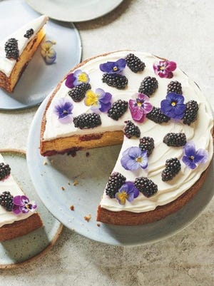 This pound cake is topped with a Greek yogurt-based topping, fresh berries and edible flowers.