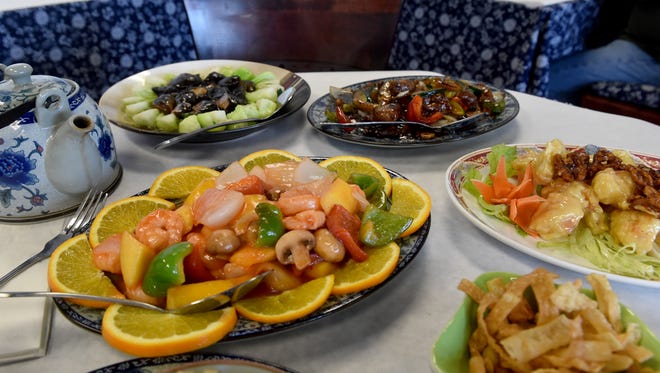 Several dishes are served during lunch at Hunan Garden restaurant in Camarillo, including mango shrimp (center), baby bok choy, filet mignion with black pepper and honey walnut shrimp.
