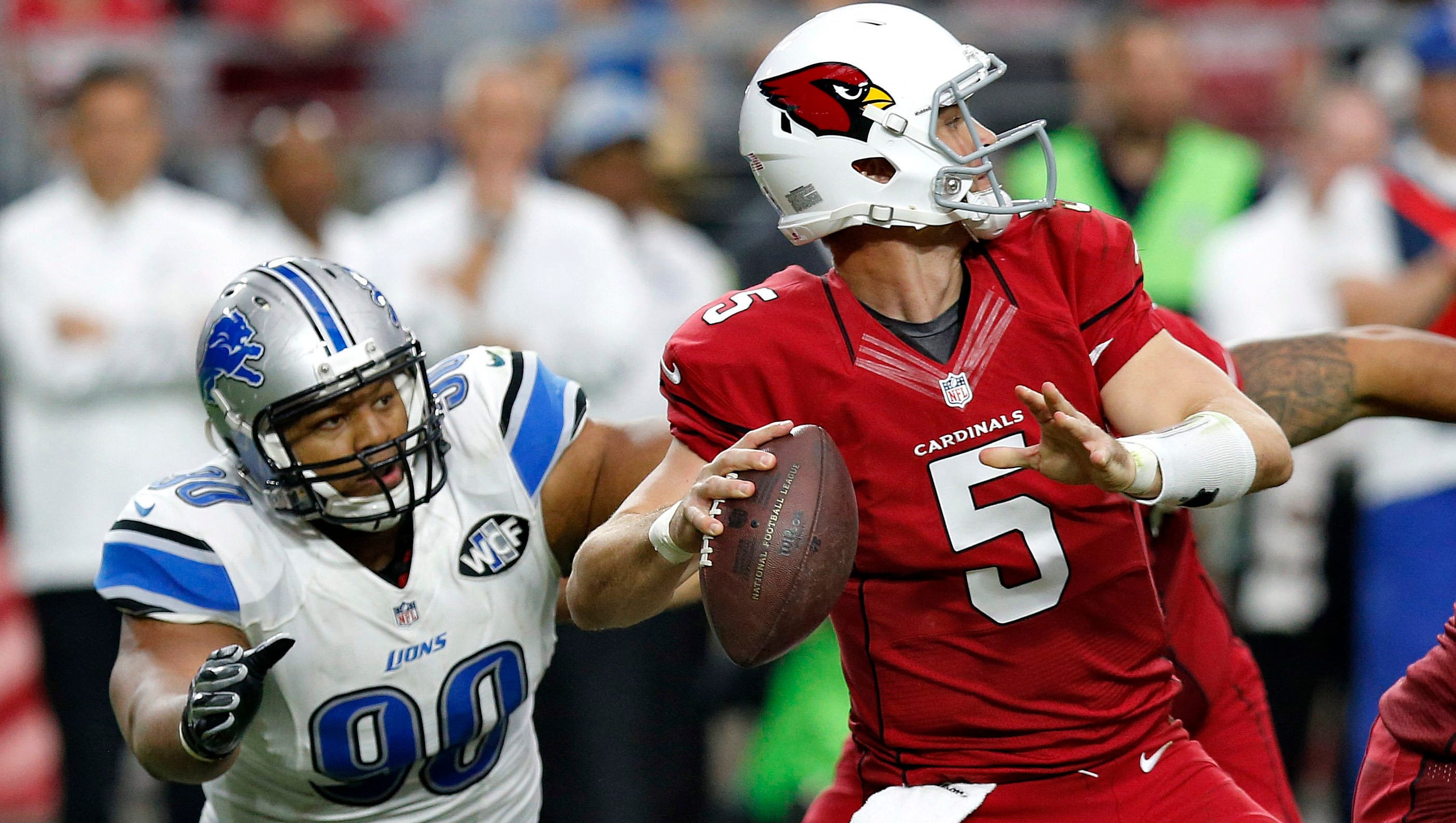Arizona Cardinals quarterback Drew Stanton looks to pass under pressure from Detroit Lions defensive tackle Ndamukong Suh (90) during the first half of an NFL football game, Sunday, Nov. 16, 2014, in Glendale, Ariz.