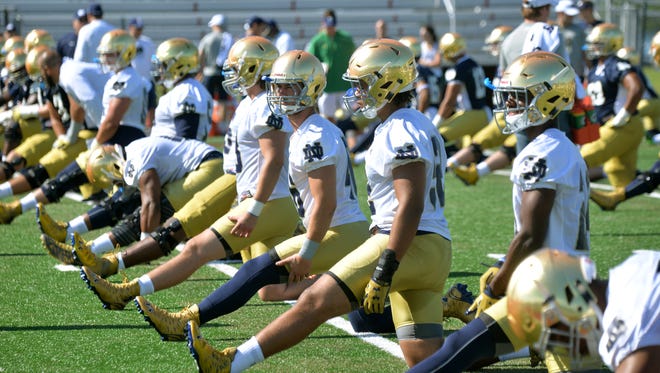 Notre Dame players loosen up during practice at an NCAA football training camp Friday, Aug. 7, 2015, in Culver, Ind.