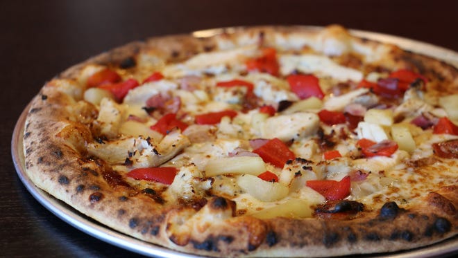 1000 Degrees Pizza serves hand-tossed Neapolitan-style pies baked in domed, revolving ovens in two minutes. Shown is the Smokey Pollo, or Barbecue Bourbon Chicken, topped with bourbon barbecue sauce, chicken, red onion, pineapple and two kinds of cheese.