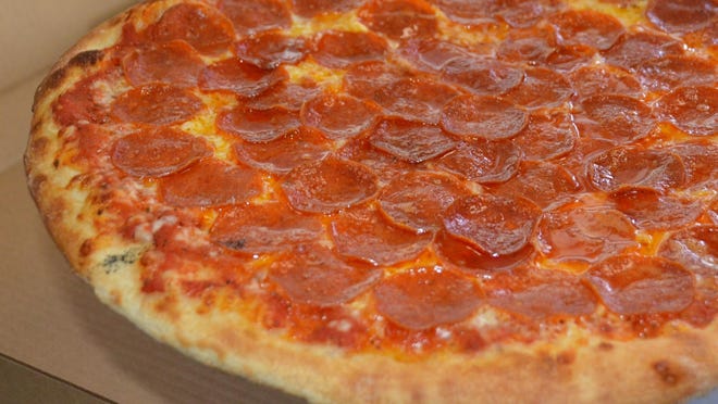 A pepperoni pizza loaded with slices of the spicy deli meat.
