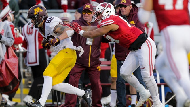 Wisconsin linebacker Dallas Jeanty pushes Minnesota wide receiver Drew Wolitarsky (82) out of bounds on a reception during the first half of an NCAA college football game Saturday, Nov. 26, 2016, in Madison, Wis. Wisconsin won 31-17. (AP Photo/Andy Manis)