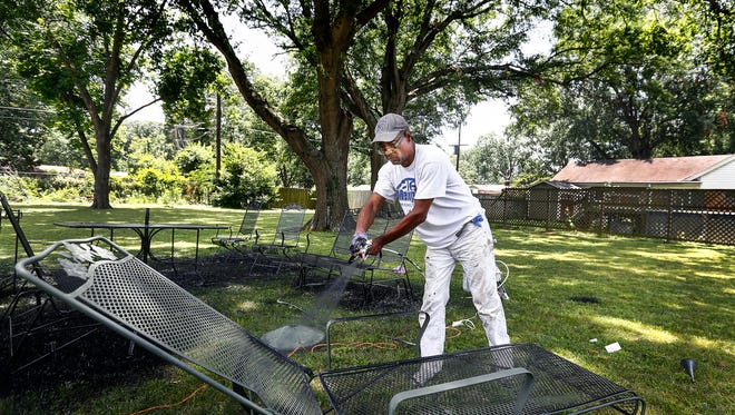 Leonard Draper works to spruce up his lawn furniture outside his Whitehaven home Friday afternoon. Draper, who bought the home with his wife in 1989, feels pained at the decline of black homeownership that does not allow people to live the "American dream." Draper says "The dream is to grow up, be able to work and take care of your family, get a home and live in peace."