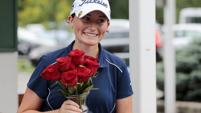 Winner Katie Hallinan accepts her prize after the championship round of the 101st annual Metropolitan Women's Amateur Championship at the Western Hills Country Club in Cincinnati on Thursday, June 23, 2016.