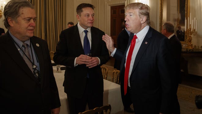 File photo taken on Feb. 3, 2017 shows President  Trump talking with Tesla and SpaceX CEO Elon Musk, center, and White House chief strategist Steve Bannon during a White House meeting with business leaders.