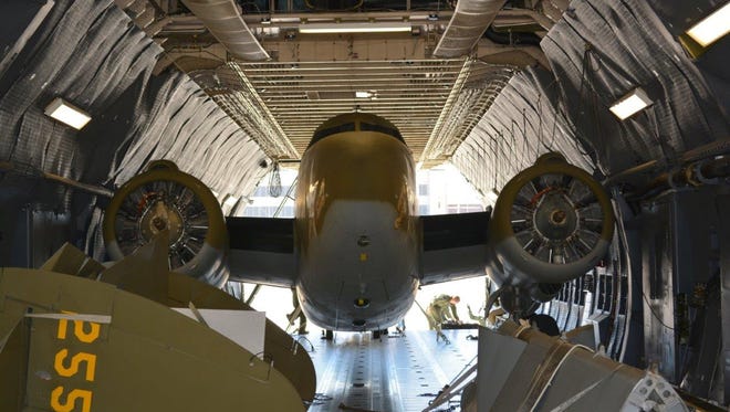 The museum's new WW II C-60 arrived via C-5M a tight fit in the modern jet's cargo compartment, with
both engines and the inboard wings still attached.