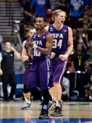 Stephen F. Austin Lumberjacks guard Trey Pinkney (10) and forward Jacob Parker (34) celebrate after defeating VCU Rams in a men's college basketball game during the second round of the 2014 NCAA Tournament at Viejas Arena.