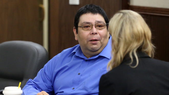 Ray Rosas talks to his attorney Lisa Greenberg after a jury acquitted him after he shot Corpus Christi police who raided his home last year on Dec. 13, 2016, 2016, at the 148th District Court in Corpus Christi.