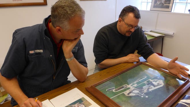 Nigel Cook, left, director of the Dairyland Initiative project, consults with Oconomowoc dairy farmer John Koepke about the design of a new building for cows that are close to giving birth.