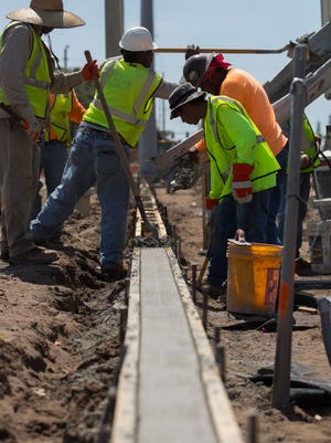 Construction workers pour concrete along a segment of SE 47th Terrace in Downtown Cape Coral, Tuesday afternoon, 5/9/18, as work continues in the streetscape project. The project will take place along SE 47th Terrace from Coronado Parkway to SE 15th Avenue.