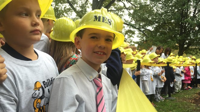 Moyer Elementary School students Ben Pfetzer and Quentin Tomlin line up among a crowd of hard hat-wearing students to break ground on a $19.1 million renovation to rebuild the Fort Thomas school scheduled to last until April 2018.