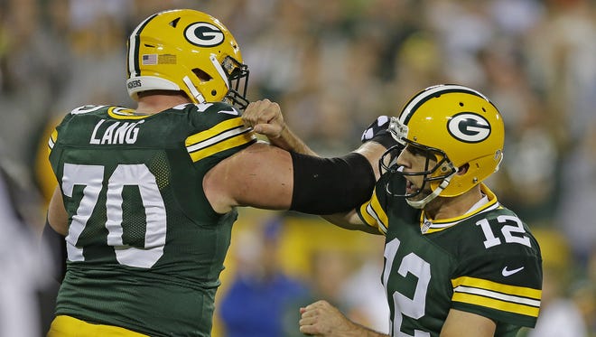 Green Bay Packers quarterback Aaron Rodgers (12) celebrates a touchdown with T.J. Lang (70) against the Kansas City Chiefs, Monday, September 28, 2015 at Lambeau Field in Green Bay, Wis.
