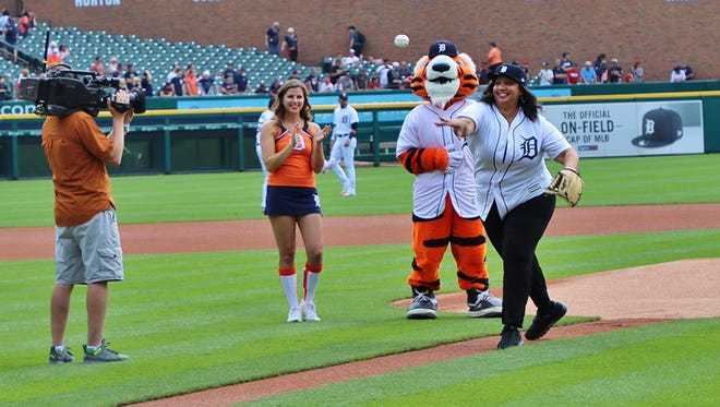 NABJ President Sarah Glover throws the first pitch at Sunday's Detroit Tigers-Cleveland Indians game at Comerica Park. One of the goals of the NABJ is connecting with the city of Detroit and its residents.
