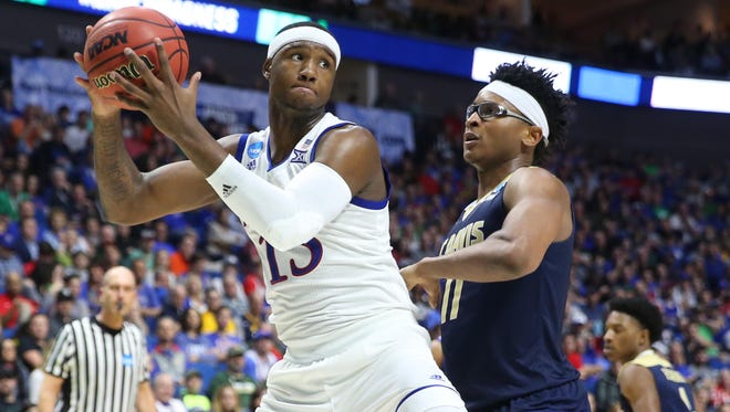 Kansas Jayhawks forward Carlton Bragg Jr. (15) works around UC Davis Aggies forward Chima Moneke (11) during the second half in the first round of the 2017 NCAA Tournament at BOK Center on March 17.