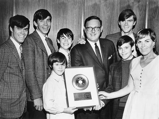 The Cowsills show off the gold record they received