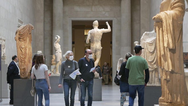 Two visitors wear masks as they walk through the Metropolitan Museum of Art in New York on March 10.