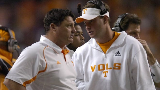 Former Vols coach Lane Kiffin talks with assistant coach Ed Orgeron during the Chick-Fil-A Bowl on Dec. 31, 2009, in Atlanta.
