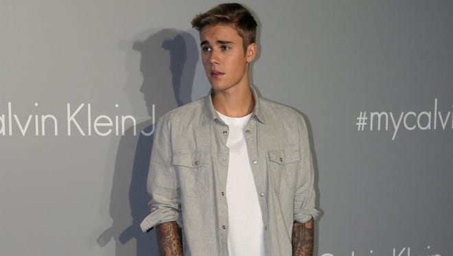 Canadian singer Justin Bieber poses for photographers upon his arrival at a promotional event for Calvin Klein in Hong Kong on June 11, 2015.