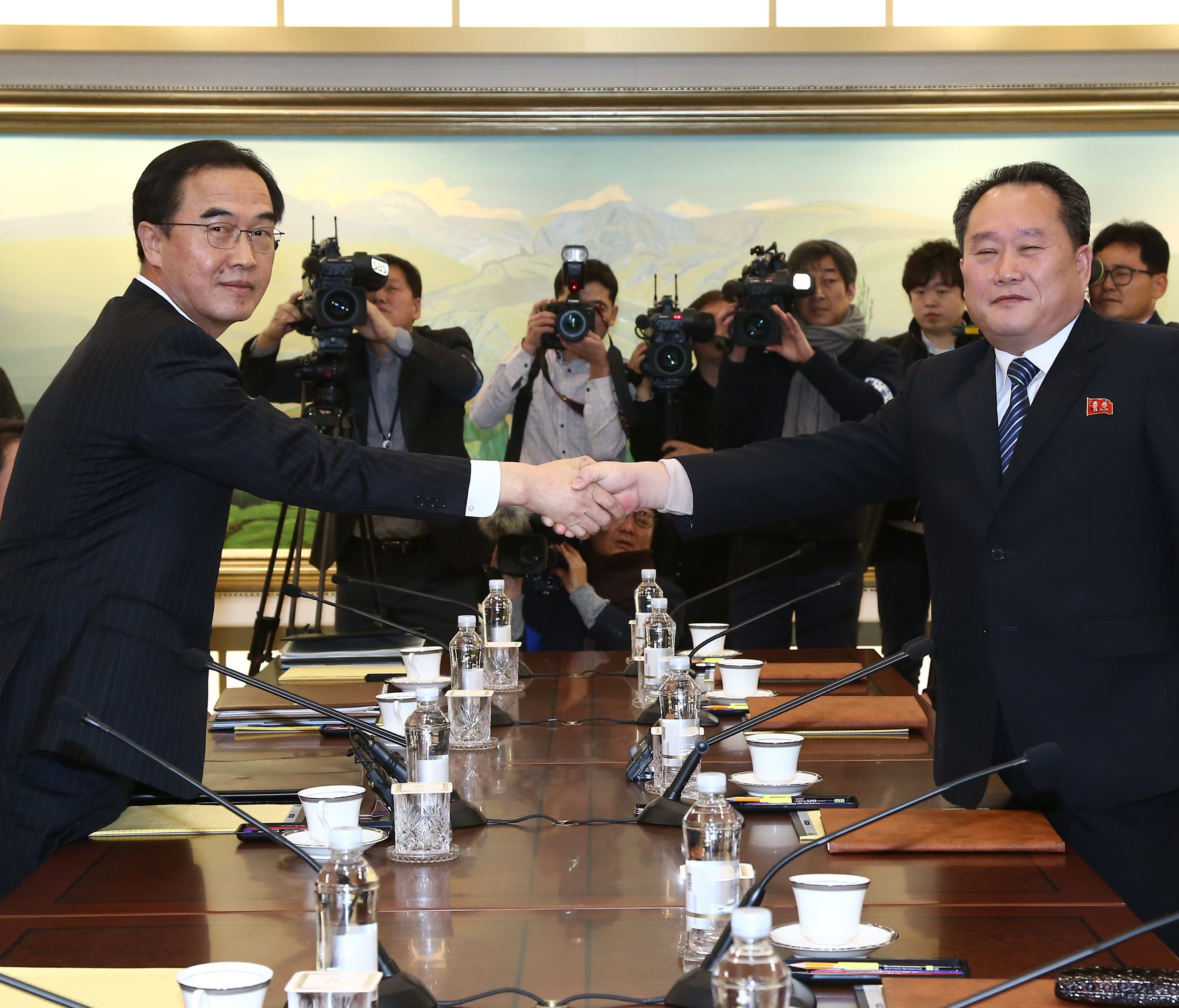 South Korean Unification Minister and chief delegate Cho Myoung-gyon (L) shakes hands with North Korea's chief delegate Ri Son-gwon (R) prior to their meeting in the truce village of Panmunjom, North Korea.