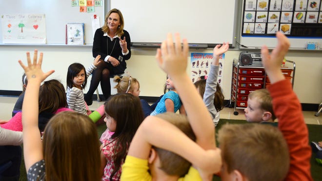 Kindergarten teacher Kathie Bridges asks her students to raise their hands to tell her stories about what happened over break at Battle Creek Elementary School on Monday, January 5, 2015, in Salem.