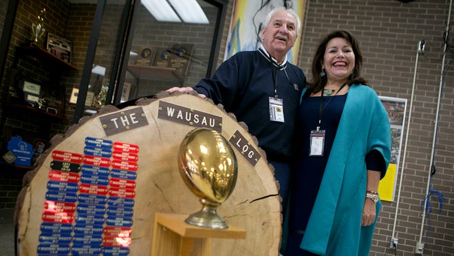 Ted Harenda, 83, of Rothschild, left, and Tina Morales of Chile pose with the Log at Wausau West High School, Thursday, Oct. 1, 2015. Harenda hosted Morales as a foreign exchange student at Wausau West and came up with the idea for the Log as part of a fundraising effort for American Field Service, which is a foreign exchange student organization.