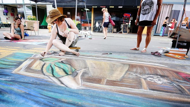 KELLY GAMPEL / Staff Photo Crystal Parks begins working on the face of her chalk subject Saturday, July 18, at the Elmira Street Painting Festival. The Erin resident won first place overall for her original piece, which portrays a woman laying in a boat. Crystal Parks begins working on the face of her chalk subject Saturday, July 18, at the Elmira Street Painting Festival. The Erin resident won first place overall for her original piece, which portrays a woman laying in a boat.