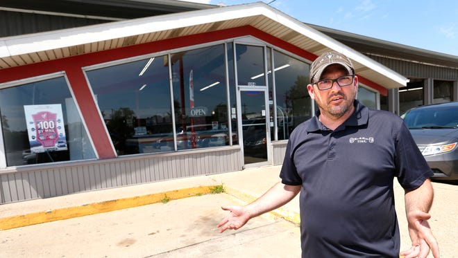 Curtis Lewis talks about the distinctive roof line over the lobby Wednesday, June 21, 2017, at Mr. & Mrs. Tire, 1094 Sagamore Parkway West in West Lafayette. Lewis, who is general manager at Mr. & Mrs. Tire, said the building once housed a Burger Chef restaurant. Lewis said Burger Chef occupied the site until 1978 or 79. After that, Lewis said it was Lanie Burton Liquor Store. Mr. & Mrs. Tire moved into the building at the end of 1983 and early 1984.