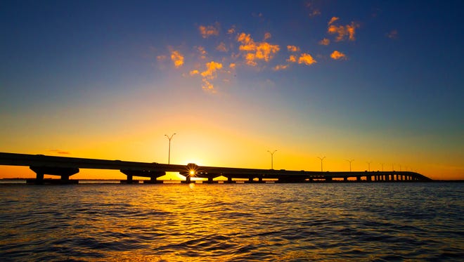 A Fort Myers to Cape Coral view of sunset over the Midpoint Memorial Bridge. The bridge opened Oct. 19, 1997.