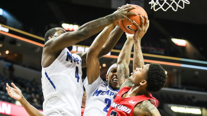 December 05, 2017 - Memphis' Raynere Thornton, 4, and Jimario Rivers, 2, battle for a rebound with Samford's Josh Sharkey during Tuesday night's game versus the Bulldogs at the FedExForum.