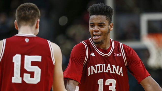 Indiana Hoosiers forward Juwan Morgan (13) celebrates with guard Zach McRoberts (15) after defeating the Notre Dame Fighting Irish 80-77 during the Crossroads Classic at Bankers Life Fieldhouse in Indianapolis on Saturday, Dec. 16, 2017.