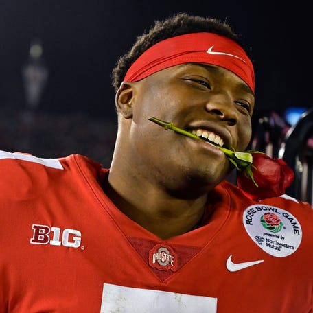 Ohio State quarterback Dwayne Haskins smiles, with a rose between his teeth, after Ohio State defeated Washington 28-23 in the Rose Bowl NCAA college football game Tuesday, Jan. 1, 2019, in Pasadena, Calif. (AP Photo/Mark J. Terrill)