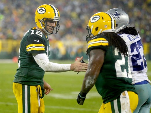 Green Bay Packers quarterback Aaron Rodgers (12) congratulates