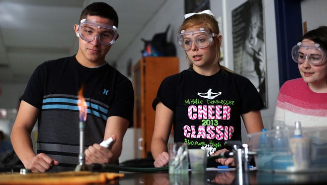 Blackman High students Ty Farris, left, Mara Kent and Anna Weeks conduct a flame test in an Advanced Placement class in 2014.