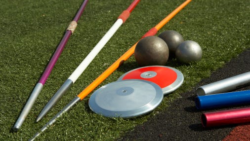 Javelins, discuses, relay batons and shots beside track
