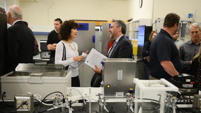 Heidi Gansert chats with Dale Erquiaga of the governor's office at the UNR Bioscience Entrepreneurial Lab which was showcased during a reception on Thursday, May 19, 2016.
