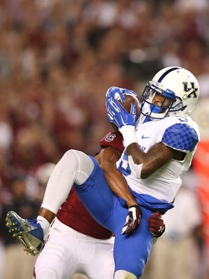Kentucky wide receiver Garrett Johnson (9) makes a catch for a first down against South Carolina's T.J. Gurley in the first half of an NCAA college football game Saturday, Sept. 12, 2015, in Columbia, S.C. (AP Photo/John Bazemore)