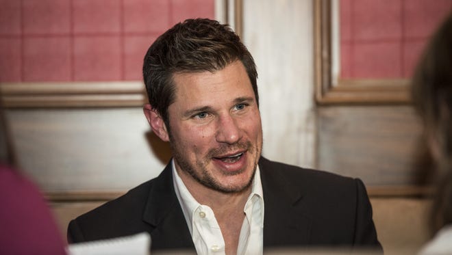 Nick Lachey talks with guests at the opening of Lachey's Bar.