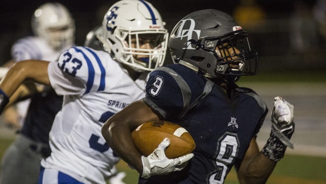 Spring Grove's Patrick Anderson (33) gives chase to Dallastown's Nyzair Smith in a Wildcat victory last September. Anderson's standout performance on and off the field helped him earn the Quarterback Club of York's annual scholarship.