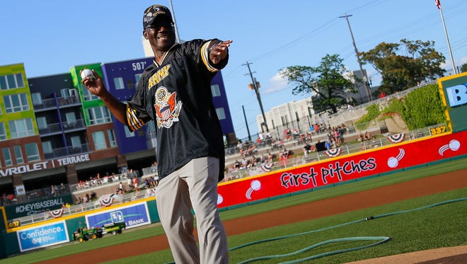 Lester Norris Jr., of Delta Township, throws the first pitch before the Lansing Lugnuts game Tuesday.