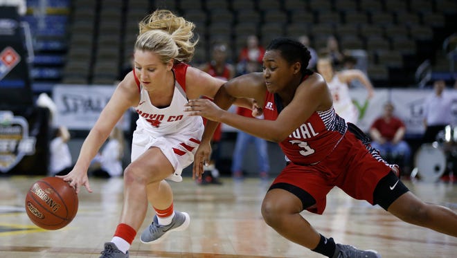 Boyd County's Savannah Wheeler, left, and Manual's Jaela Johnson, 3, chase down a loose ball during a quarter final game in the St. Elizabeth Healthcare/KHSAA Girls' Sweet 16 basketball tournament played at BB&T Arena in Highland Height, Ky. Friday March 9, 2018.