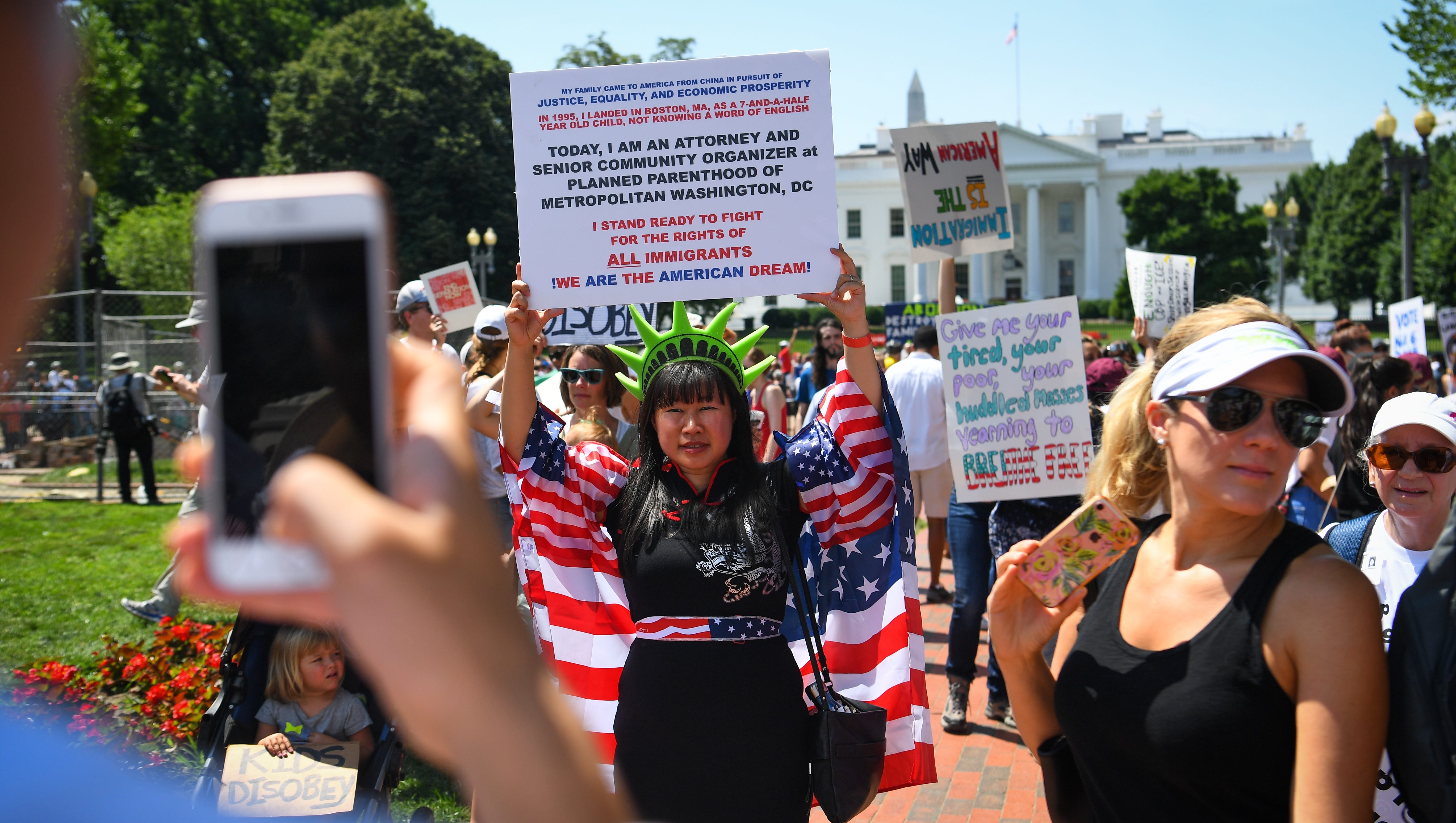 Quinnie Lin, of Washington, stands with people in front