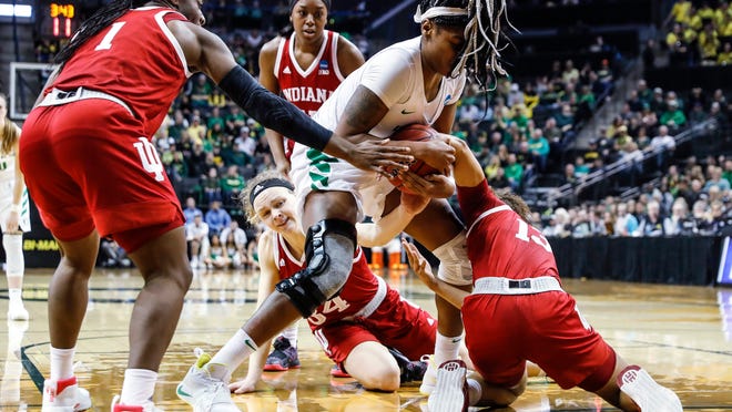 Oregon forward Ruthy Hebard (24), fights for a loose ball against Indiana guard Jaelynn Penn (13), during a second-round game of the NCAA women's college basketball tournament Sunday, March 24, 2019, in Eugene, Ore. (AP Photo/Thomas Boyd)