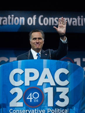 Mitt Romney waves after addressing the Conservative Political Action Conference in National Harbor, Maryland, on March 15, 2013.
