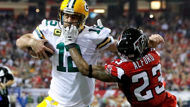 ATLANTA, GA - JANUARY 22:  Robert Alford #23 of the Atlanta Falcons attempts to tackle Aaron Rodgers #12 of the Green Bay Packers in the fourth quarter in the NFC Championship Game at the Georgia Dome on January 22, 2017 in Atlanta, Georgia.  (Photo by Kevin C. Cox/Getty Images)