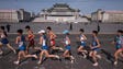  Competitors run through Kim Il-Sung square during