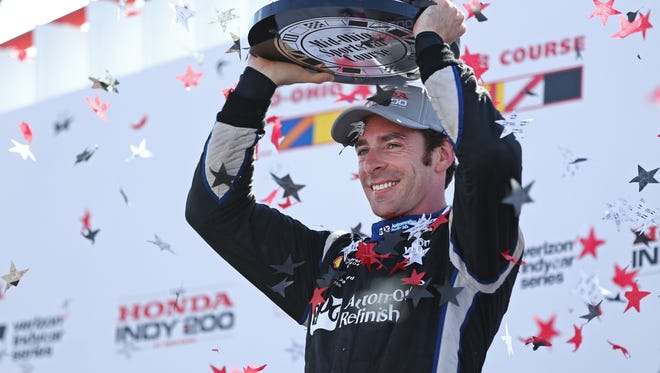 Indy Car Series driver Simon Pagenaud celebrates winning the Honda Indy 200 at Mid-Ohio Sports Car Course.