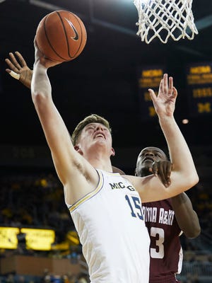 Michigan center Jon Teske (15) shoots and is fouled by Alabama A&M forward Mohamed Sherif (23) in the first half on Thursday, Dec. 21, 2017, at Crisler Center.